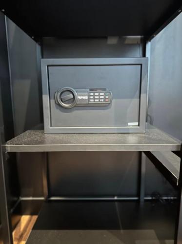 a microwave oven sitting on a shelf in a kitchen at La Suite H in Metz