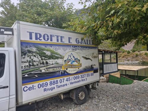 a truck is parked in front of a building at I Love Koman Camping in Shkodër