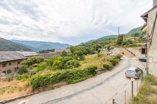 a car parked on a road in a village at Apartament Garrota in Olp