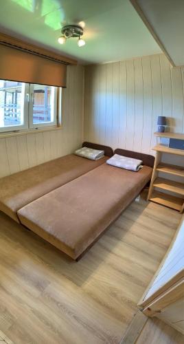 a bedroom with a large bed in a room at 50m od Jeziora - Dom wakacyjny in Zawóz
