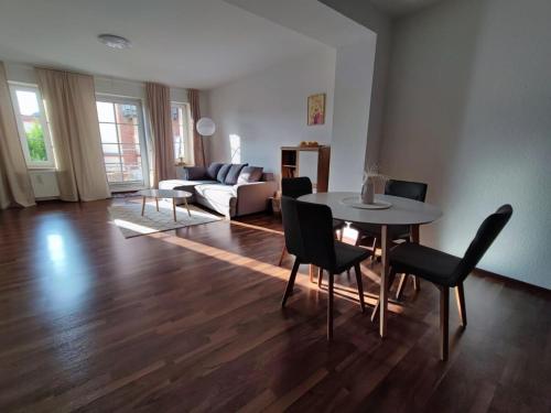 a living room with a table and chairs and a couch at Ferienwohnung Alte Mühle in Freital bei Dresden in Freital