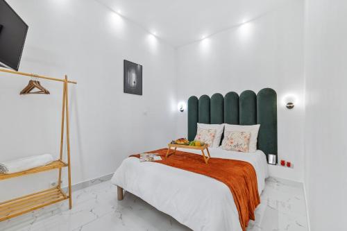 a bedroom with a large bed with a green headboard at Le SEPT MARTINE Hyper centre - Air-conditioned - Terrace - Quiet - Wifi - Tramway in Nice