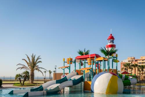 a water park with a water slide and a lighthouse at ALEGRIA Colonial Mar Aquafun in Roquetas de Mar