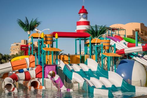 a water park with a water slide and a lighthouse at ALEGRIA Colonial Mar Aquafun in Roquetas de Mar