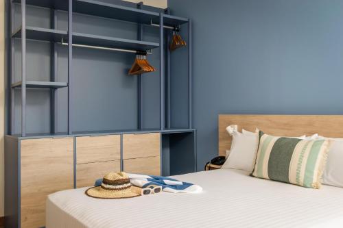 a bedroom with two beds with a hat on top at ALEGRIA Colonial Mar Aquafun in Roquetas de Mar