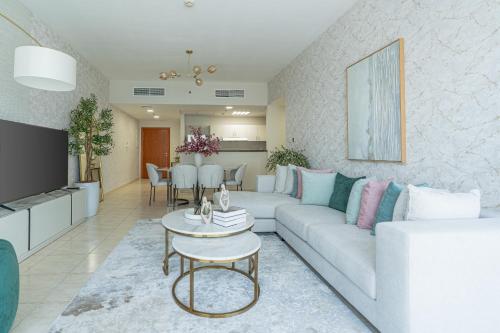 a living room with a couch and a table at Nasma Luxury Stays - Sky-High Serenity in Stylish 2BR Retreat in Dubai