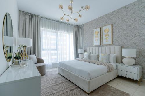 a bedroom with a large white bed and a window at Nasma Luxury Stays - Sky-High Serenity in Stylish 2BR Retreat in Dubai