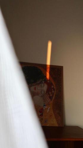 a candle sitting on a shelf next to a picture at Periopto Maisonette House in Mastambás