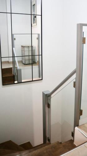 a mirror on the wall next to a stairway at Periopto Maisonette House in Mastambás
