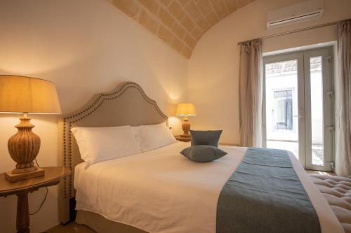 Masseriola Antiche Fogge by Apulia Hospitalityにあるベッド