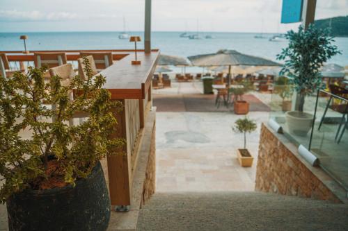 a view of a patio with plants and the ocean at Ionion Beach Resort in Parga