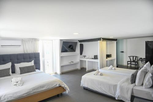 Postel nebo postele na pokoji v ubytování Mykonos Kosmoplaz Beach Resort Hotel