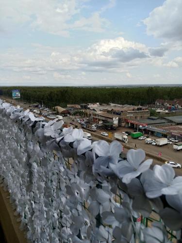a row of white umbrellas on top of a building at Relax Crib Kamakis in Ruiru