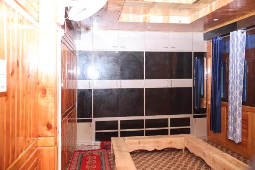 a room with a black and white tiled wall at Bhaskar Villa in Sainj