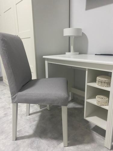 a chair sitting in front of a desk with a table at Annarè Home in Vasto