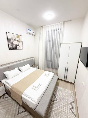 a bedroom with a large bed in a room at SADI Hotel in Yakkasaray
