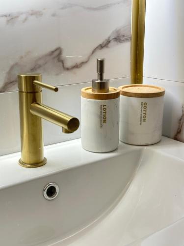 a bathroom sink with three cups and a faucet at Studio MBS 2- Cosy, Tramway, Wifi, Parking, Equipé in Montpellier
