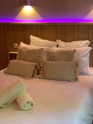 a large white bed with pillows and a towel on it at Studio MBS 2- Cosy, Tramway, Wifi, Parking, Equipé in Montpellier