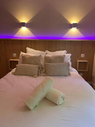 a large white bed with a towel on it at Studio MBS 2- Cosy, Tramway, Wifi, Parking, Equipé in Montpellier