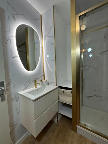 a white bathroom with a sink and a mirror at Studio MBS 2- Cosy, Tramway, Wifi, Parking, Equipé in Montpellier