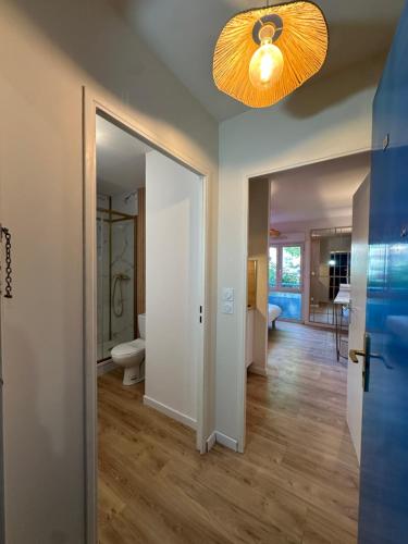 a hallway with a bathroom and a ceiling light at Studio MBS 2- Cosy, Tramway, Wifi, Parking, Equipé in Montpellier