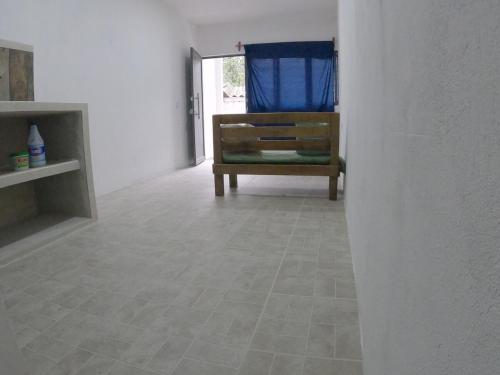 a living room with a chair and a tile floor at Depto Zona UV Lagos Isleta 103 in Xalapa