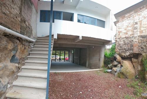 a house with a staircase leading to a building at Depto Zona UV Lagos Isleta 103 in Xalapa