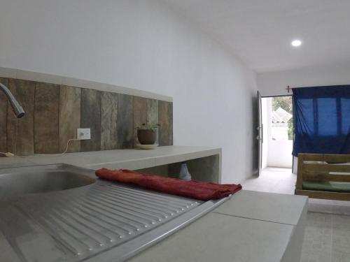 a kitchen with a sink with a red towel on it at Depto Zona UV Lagos Isleta 103 in Xalapa
