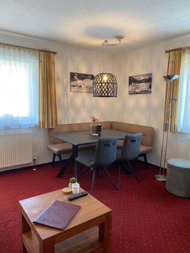 a living room with a table and a couch at Chalet Rotenstein in Berwang