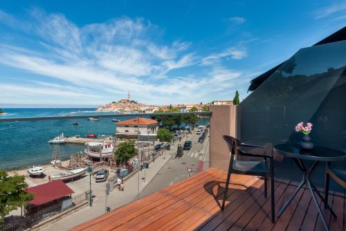 a balcony with a view of a harbor and the ocean at Hotel Squero in Rovinj