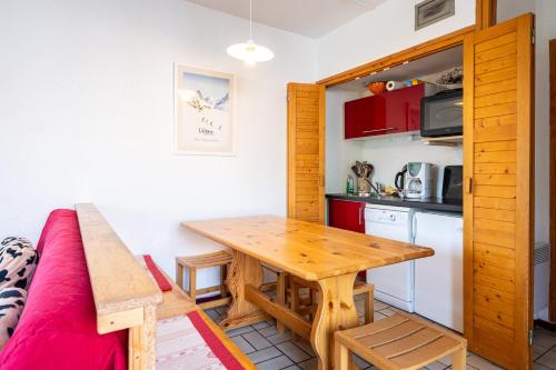 - une cuisine et une salle à manger avec une table et un canapé dans l'établissement Les Arolles n°G54, à Valloire