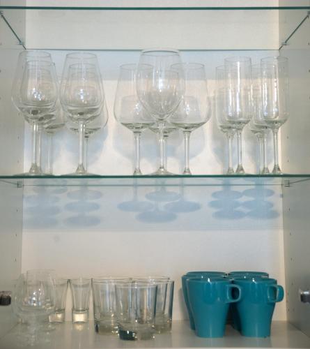 a bunch of wine glasses sitting on a shelf at Hotelli Olof in Tornio