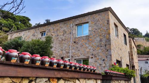 a building with red and white dishes on a ledge at 津沙小筑 in Nangan