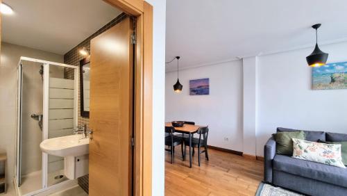 two images of a bathroom and a living room at Apartamento El Castro de Borizu in Celorio