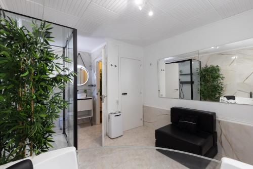 a room with a glass table and a chair and a mirror at Villa Frades in Salou