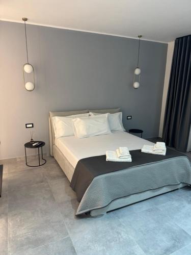 a bedroom with a bed with two towels on it at Casa margherita in Bova Marina