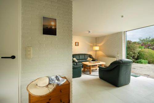 a living room with two chairs and a table at De Duiker in Wolphaartsdijk