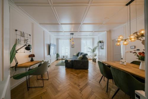 a living room with a couch and a table at Central Boutique Apartment - Garden with Riveraccess in Thun