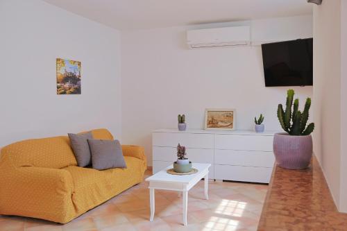 a living room with a couch and a tv at Villa Lella - Pantheon in Ardea