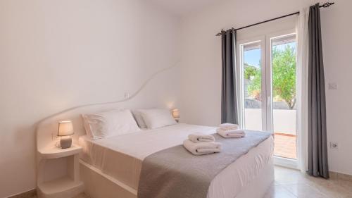 a bedroom with a bed with two towels on it at Vounala Studio in Pollonia
