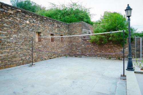 a stone wall with a basketball hoop in front of it at Madri Haveli in Udaipur
