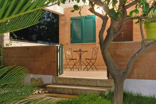 a patio with a table and chairs on a house at Villa Lella - Pantheon in Ardea