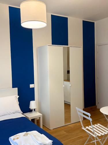 a bedroom with blue walls and a bed and a chair at Art Room In Pompei in Scafati