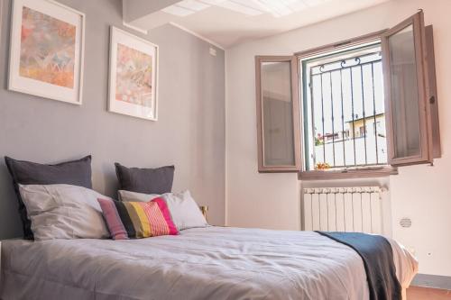 a bedroom with a bed and a window at Cozy Bruni House in Florence in Florence