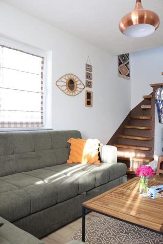 a living room with a couch and a table at House Trebević ReStart in Petruše
