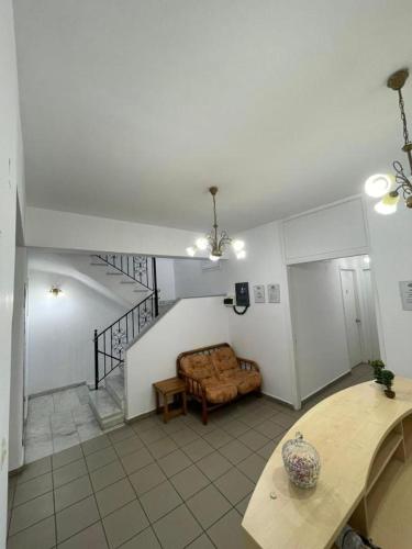 a living room with a couch and a table at Syros Studios in Ermoupoli