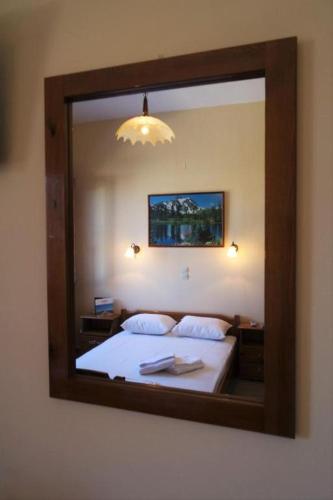 a mirror reflection of a bed in a bedroom at Syros Studios in Ermoupoli