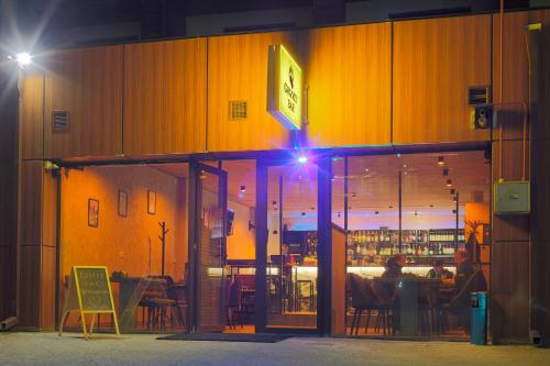 a person sitting at a table in a restaurant at night at New Gudauri Loft 1 in Gudauri