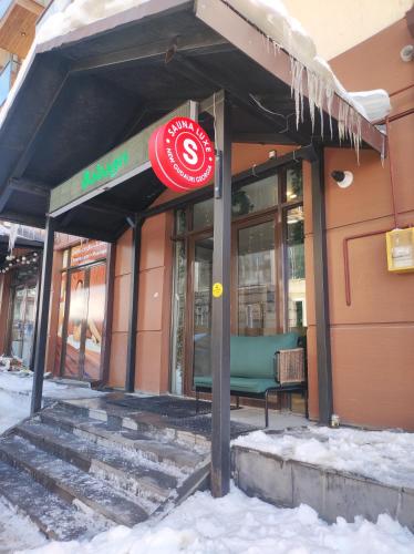 a store front with a stop sign in the snow at New Gudauri Loft 1 in Gudauri