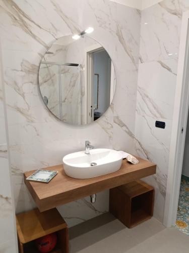 a bathroom with a sink and a mirror at Room with a view in Salerno